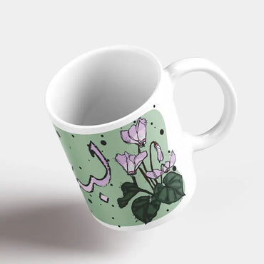 Green Lebanese mugs with the cyclamen flower sketched and Lebanon written in Arabic. Lebanese Floral mug