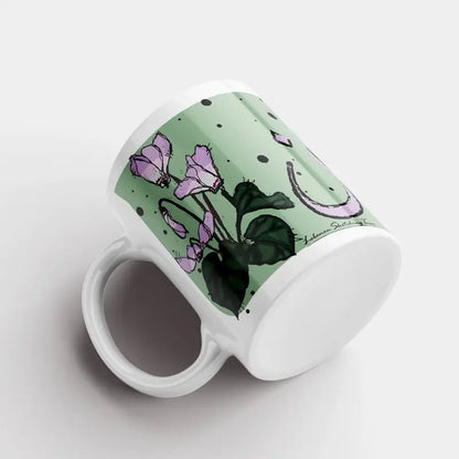 Green Lebanese mugs with the cyclamen flower sketched and Lebanon written in Arabic. Lebanese Floral mug